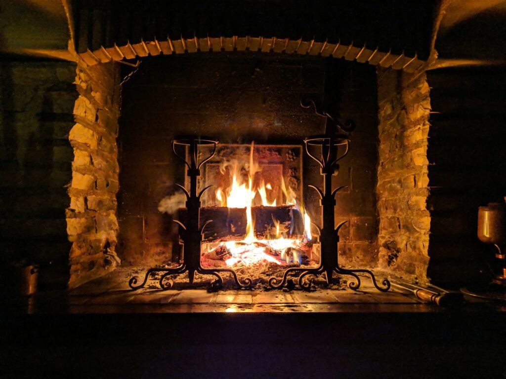 Log fireplace with a lit fire