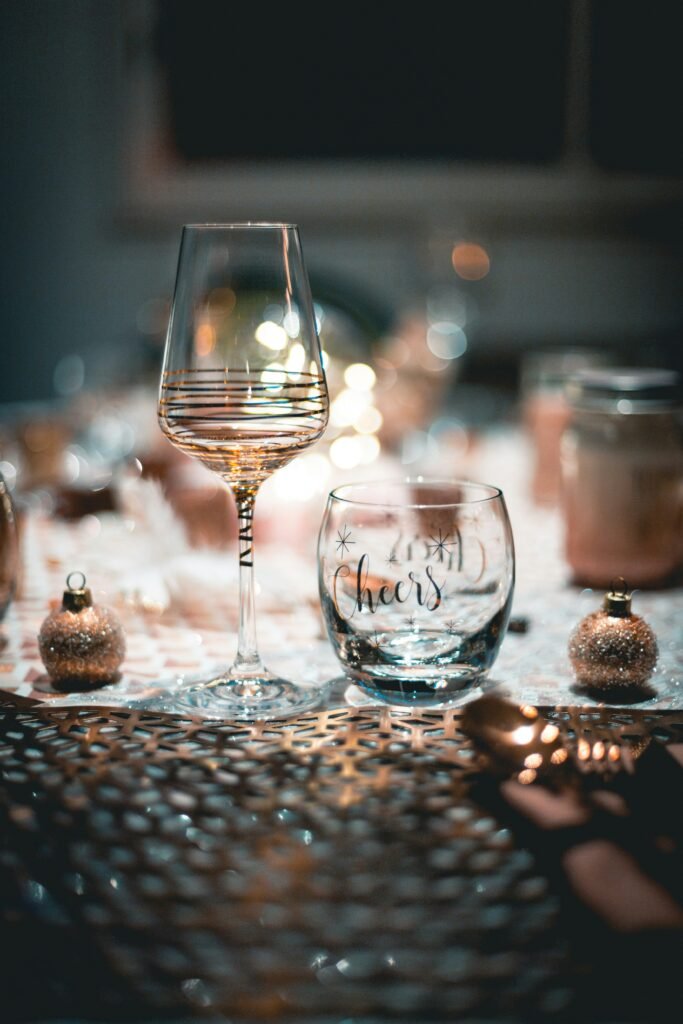 wine and water glasses on a decorated table for christmas